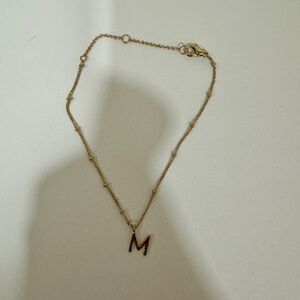 Gold toned M bracelet​​​​​​​​​